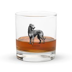 a glass with a dog drawn on the front and side, sitting in front of a white background