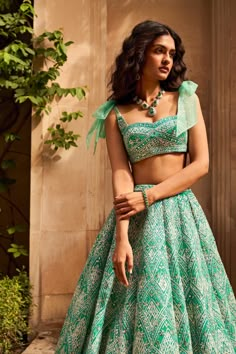 Sea green Maddie Lehenga. Seema Gujral: This lehenga set features a multi-layered net lehenga with different shades of sea green and is appliqued in a geometric pattern. The skirt is paired with a blouse with a bow tie on the shoulder. Weddings 2024, Orang India, Seema Gujral, Indian Outfits Lehenga, Dresses Traditional, Lehenga Designs Simple, Traditional Indian Dress