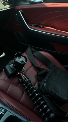 the interior of a car with red and black leather seats, steering wheel controls and other accessories