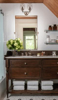 a bathroom with a sink, mirror and shelves