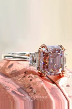 an engagement ring with a fancy pink diamond