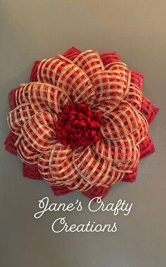 a red and white flower with the words jane's crafty creations on it