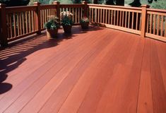 a wooden deck with potted plants on it