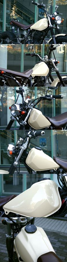 several motorcycles are parked in front of a building with glass windows on the side of it