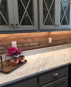 a kitchen counter top with some flowers on it