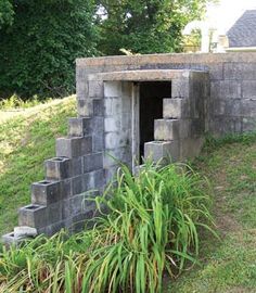 there is a cement structure that looks like it has been built into the ground