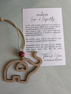 an elephant ornament with a note attached to it