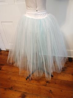 a white tulle skirt on display in front of a door