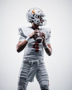 a football player holding a ball in his hands