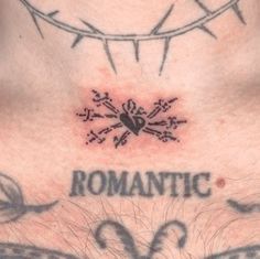 the chest is covered with tattoos and barbed wire above it, which reads romantic love