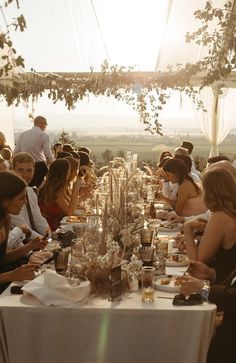 a group of people sitting around a long table