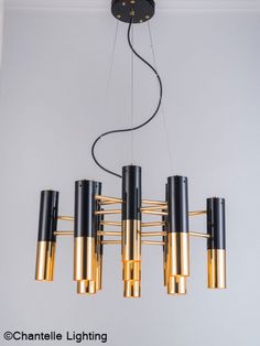 a chandelier with eight lights hanging from it's sides in a room