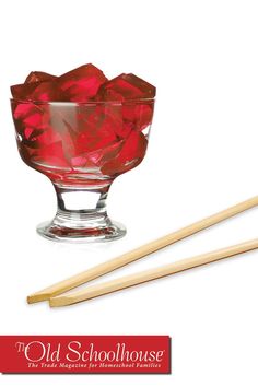 an old schoolhouse glass bowl with chopsticks next to it and the words old schoolhouse written in red