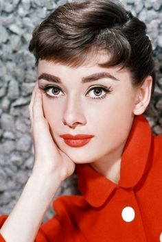 a woman with short hair wearing a red shirt and white polka dots on her lips