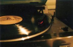 an old record player is playing on the turntable