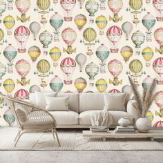 a living room filled with furniture and wallpaper covered in hot air balloons