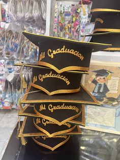 graduation caps are stacked on top of each other in front of a store display case