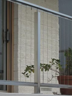 a potted plant sitting on top of a window sill next to a sliding glass door