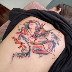 a woman with a colorful tattoo on her back