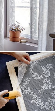 a person is cutting fabric with scissors on the window sill next to a potted plant