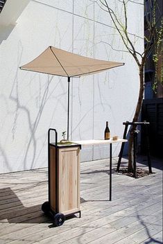 an umbrella and table on a wooden deck