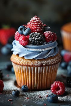 a cupcake with berries and blueberries on top