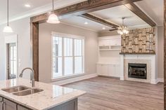 an empty kitchen and living room in a new home