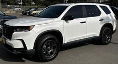 a white suv parked in a parking lot