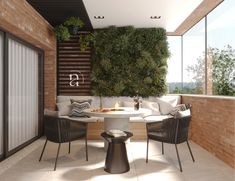 an outdoor living room with plants on the wall