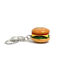 a hamburger shaped keychain with a chain attached to it's side, on a white background