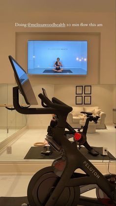 an exercise bike in front of a flat screen tv