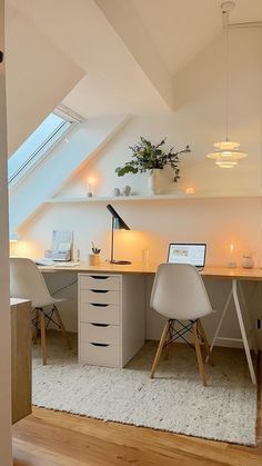 a room with a desk, chair and laptop on top of the table in it