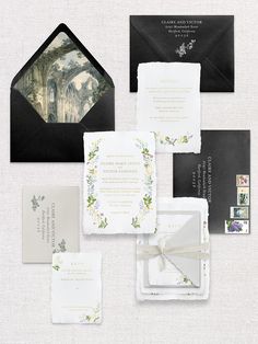 an assortment of wedding stationery items including envelopes, cards, and napkins