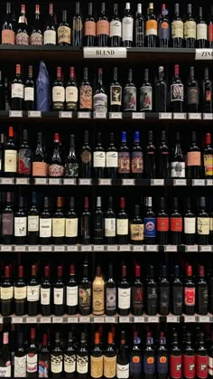 many bottles of wine are lined up on the shelves in this liquor store, and there is no image here to provide a caption