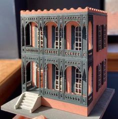 a model of a building made out of paper with windows and balconies on top