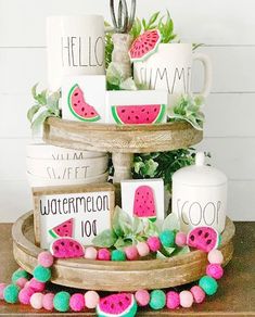 a cake with watermelon slices on it and other decorations around the top tier