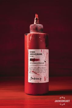 a red fire extinguisher sitting on top of a wooden table