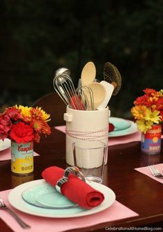 the table is set with utensils and flowers