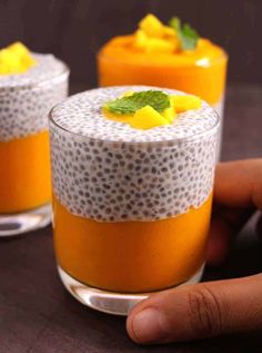 two glasses filled with orange and white dessert