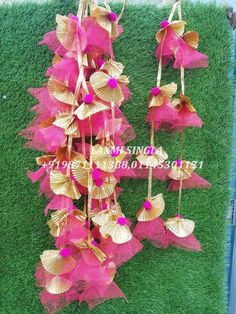 pink and gold flowers are hanging from the grass