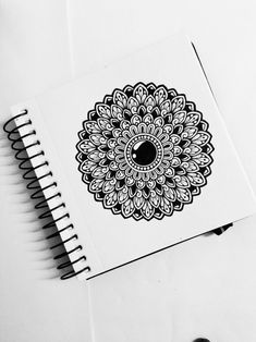 a spiral notebook with a black and white design on it