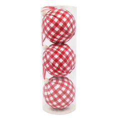 three red and white checkered balls in a clear tube on a white background photo