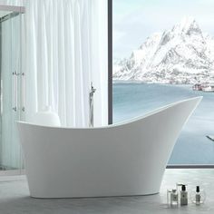 a white bath tub sitting next to a window