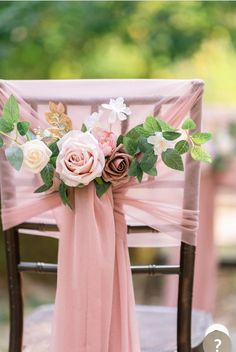 a chair decorated with flowers and greenery