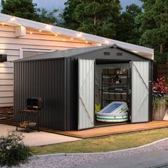 an outdoor storage shed with a mattress in the door and lights on the side of it