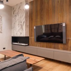 a large flat screen tv mounted to the side of a wall in a living room