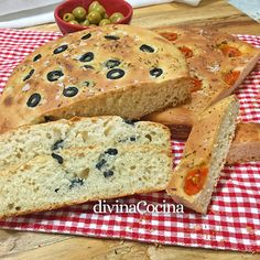 bread with olives and cheese on a red checkered tablecloth