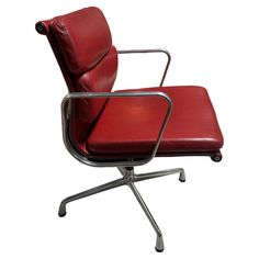 an office chair with red leather upholstered on the back and chrome frame legs