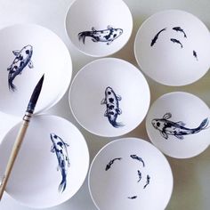 several bowls with fish painted on them