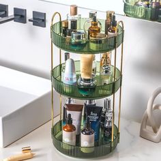 a three tiered shelf with bottles and other personal care items on it next to a sink